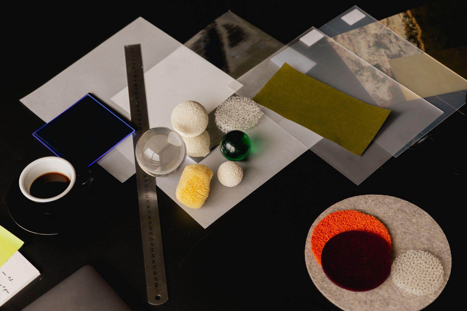 A desk from above with a ruler, swatches and small objects