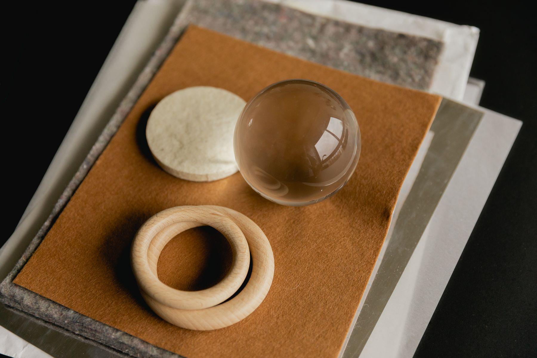 Material samples and wooden rings laid on a stack of boards