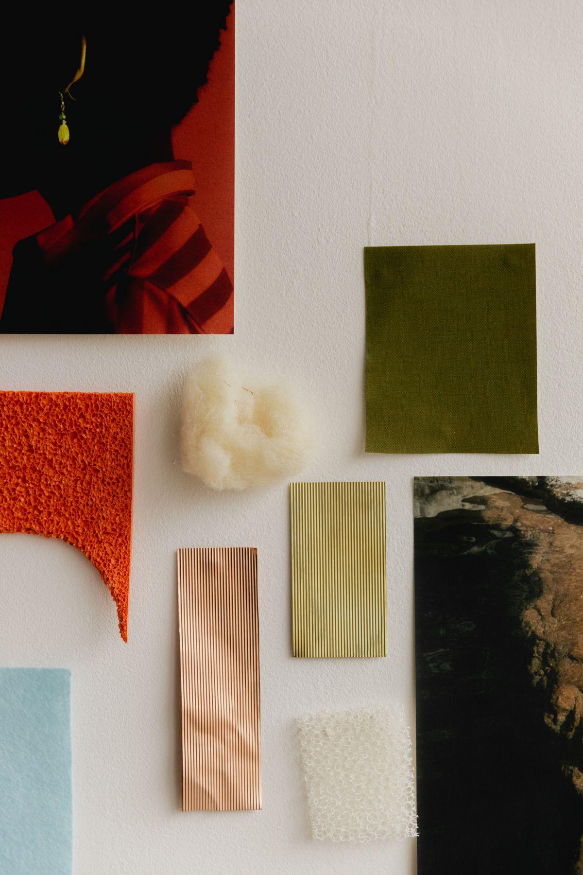 Color and material swatches pinned in a row on a white wall