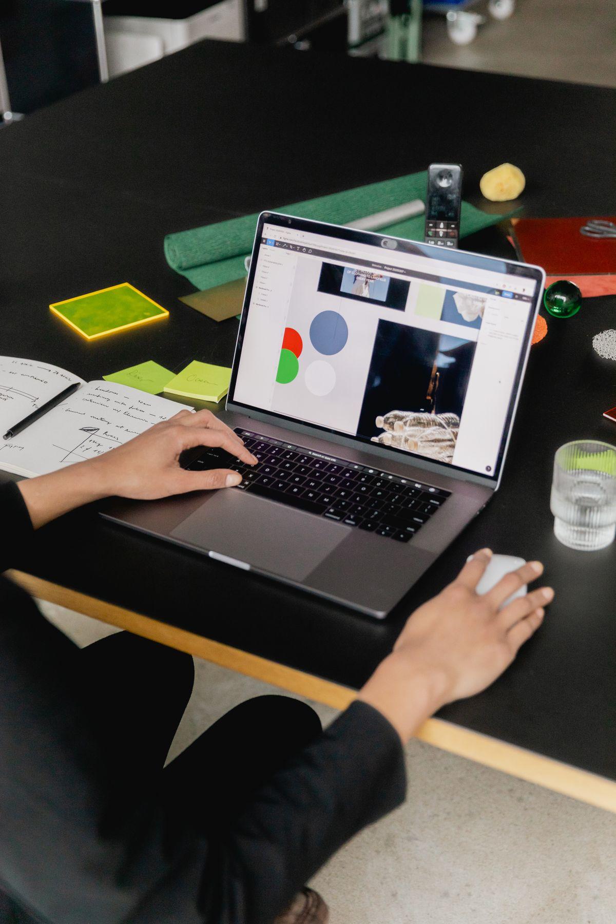 Hands on a laptop keyboard with a web page on screen