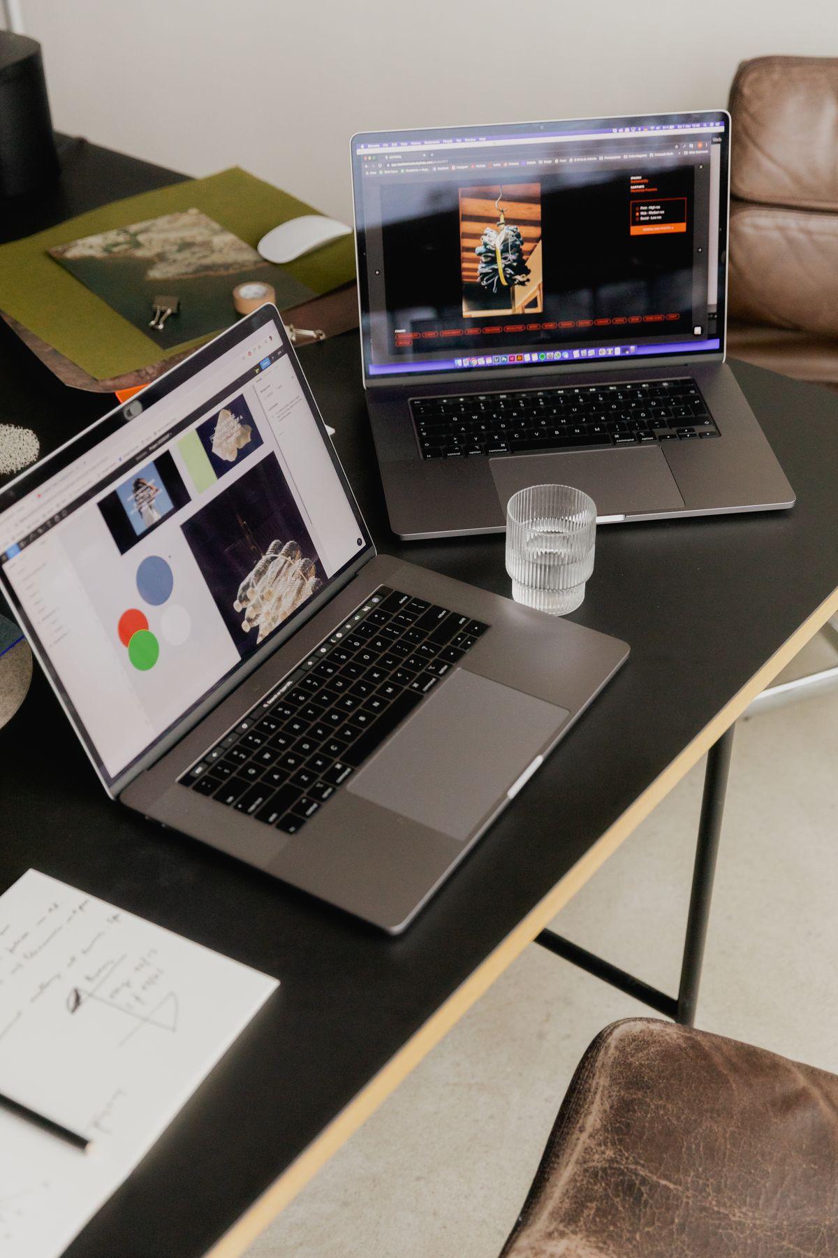 Two laptops side by side showing web pages