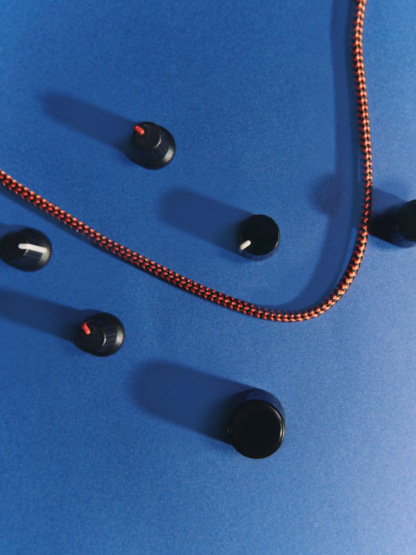 Scattered knobs and a braided cable on blue