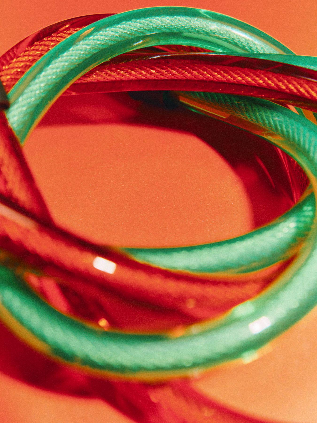 Coiled red and green cables on an orange background