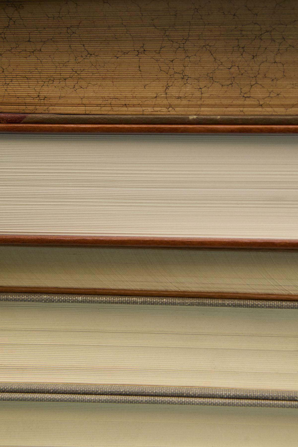 The edges of a stack of old books