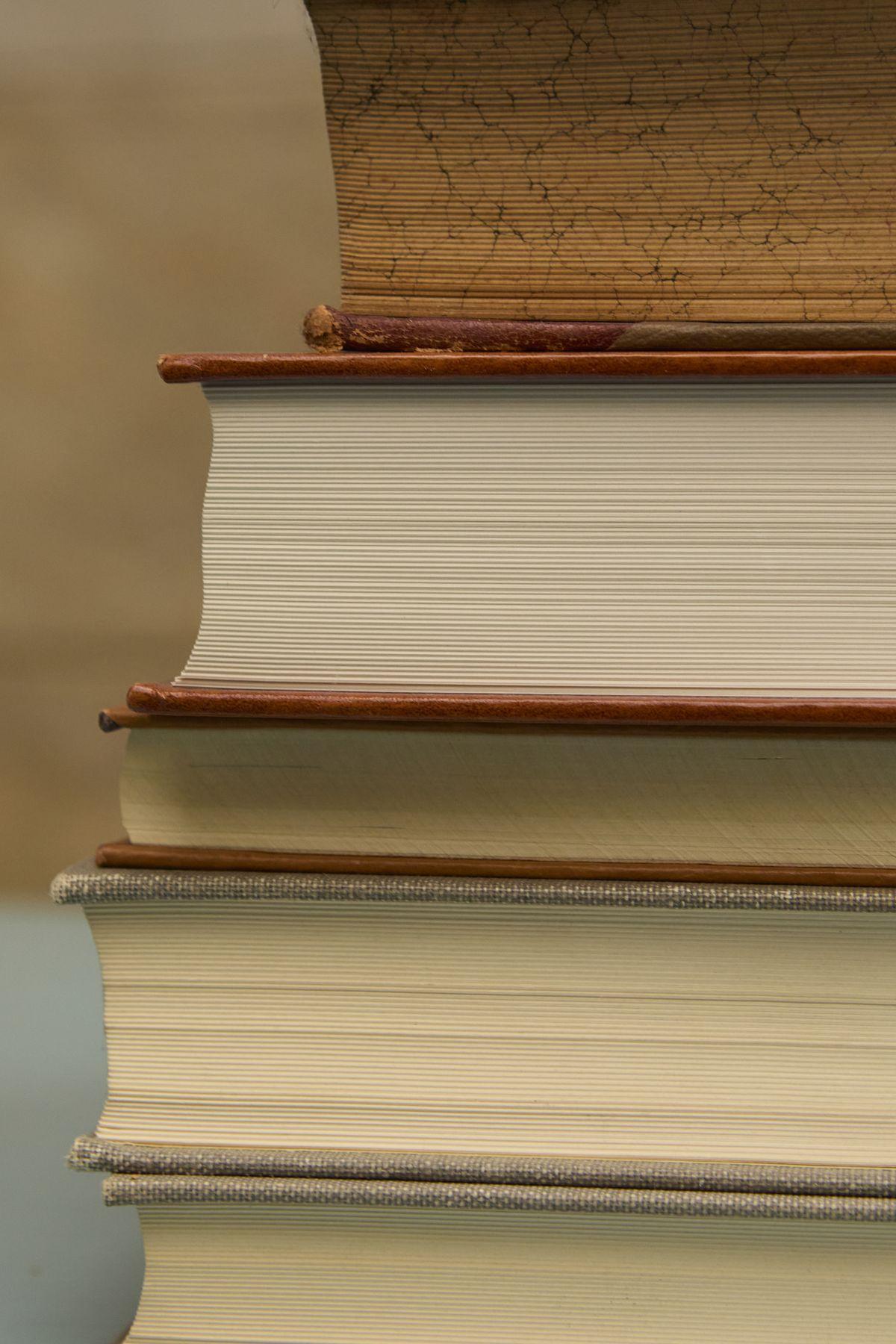 A tall stack of books seen from the side