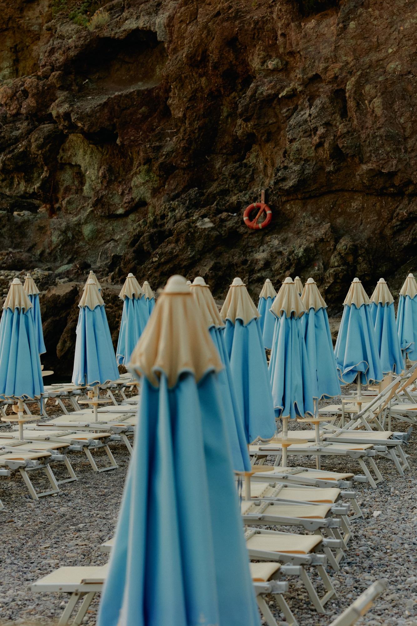 Rows of closed beach umbrellas waiting to open