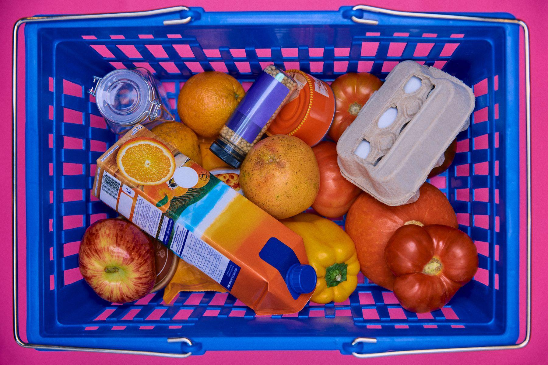 A blue shopping basket full of fruit seen from above