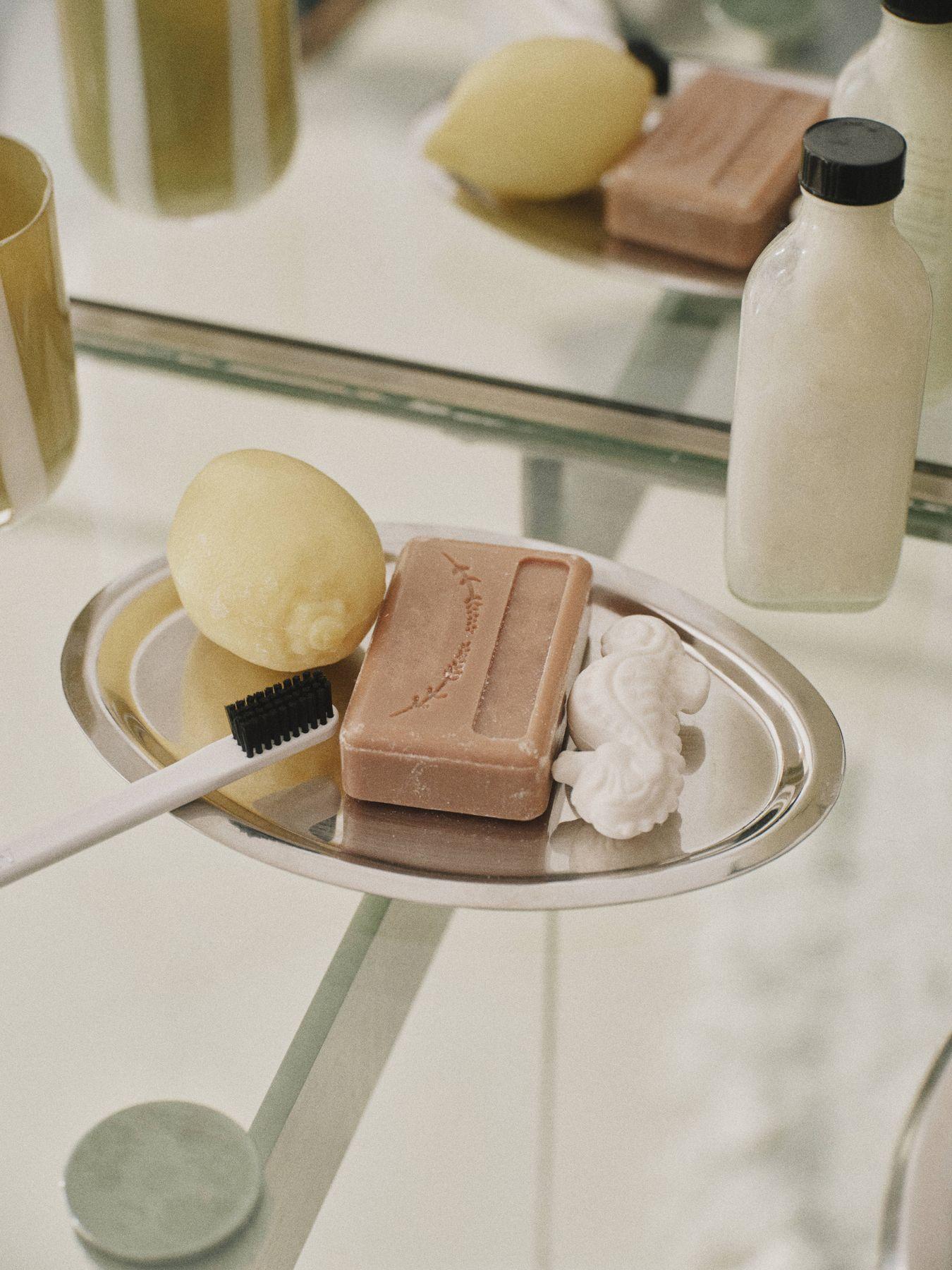 Soap, a lemon and a brush on a silver tray