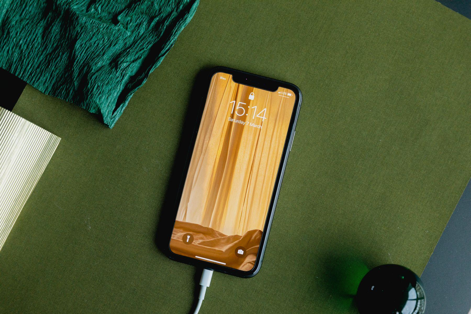 A phone resting on an orange textured mat