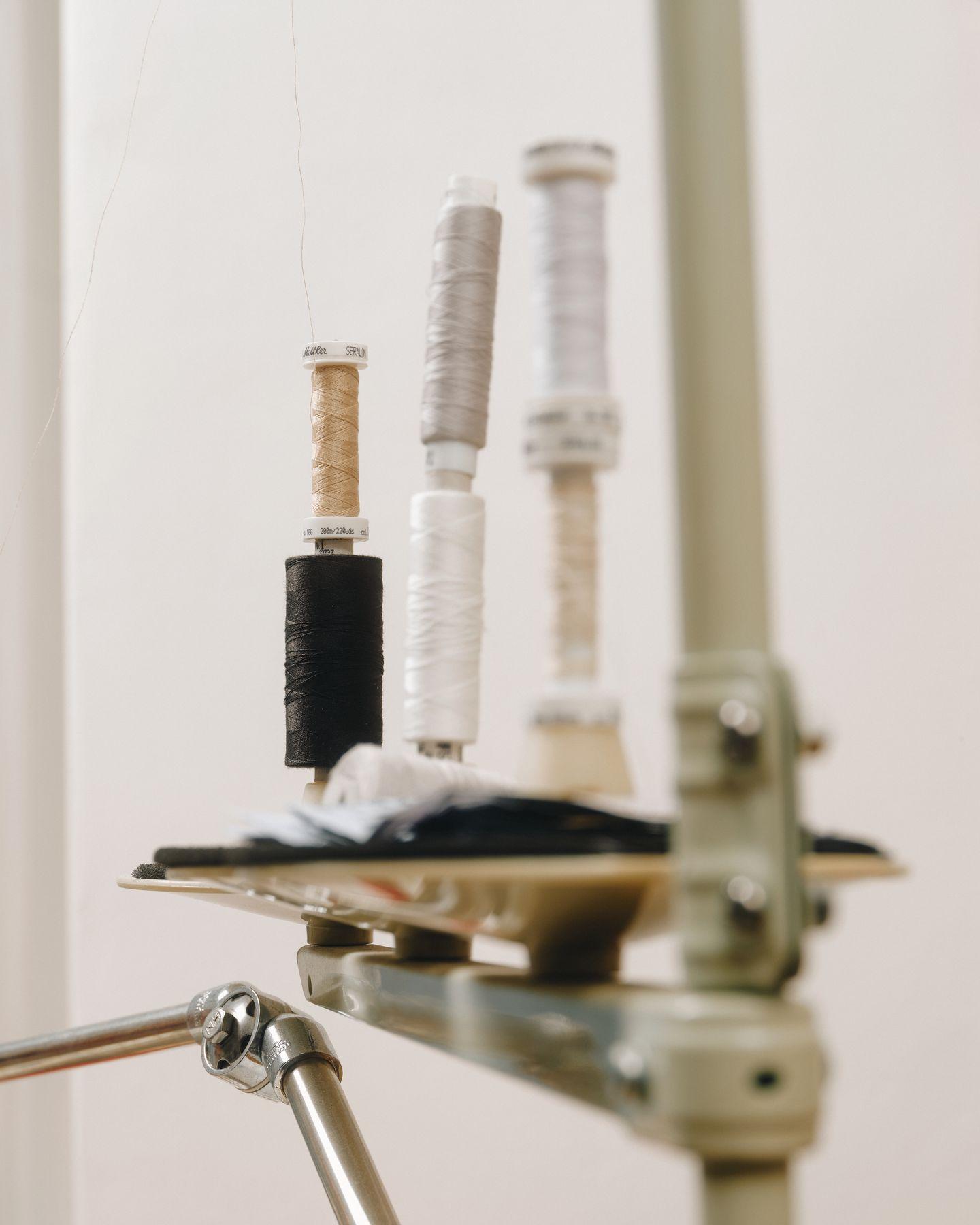 Spools of thread on a stand in a workshop