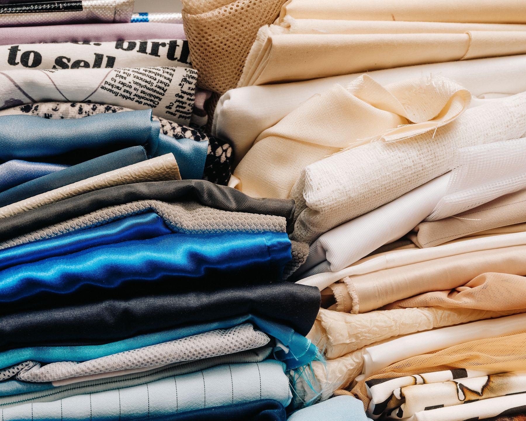 Folded fabrics stacked in rows by color