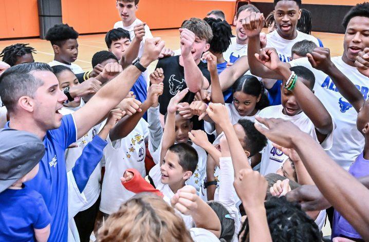 WHJESP coaches and young athletes in a team huddle
